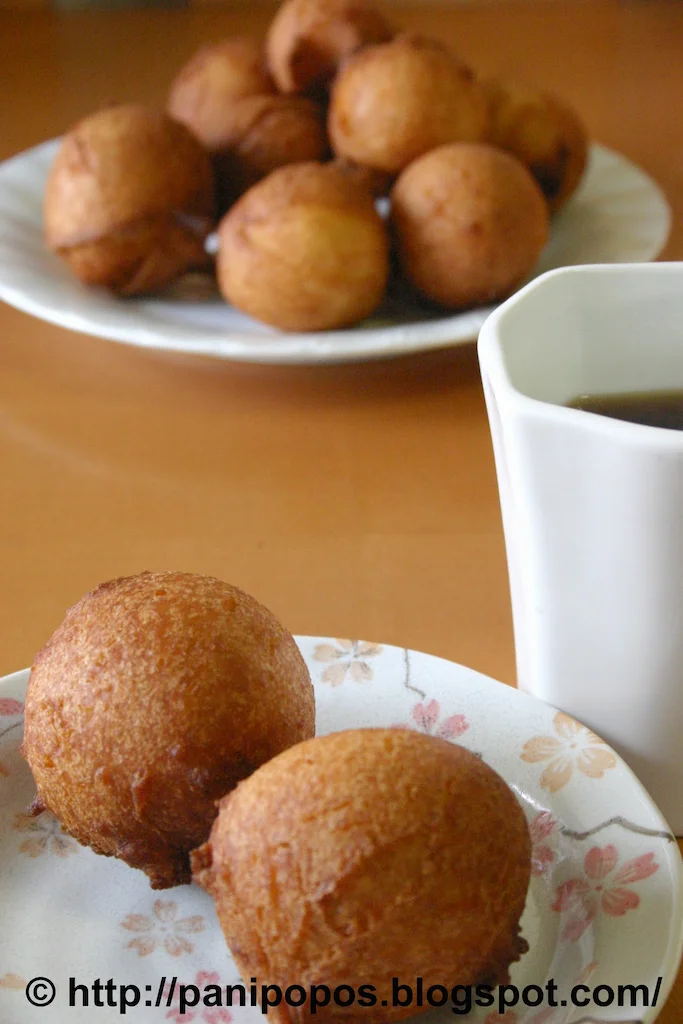 Panikeke on a plate next to a beverage.