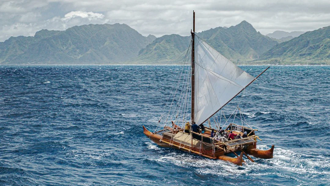 Iosepa, a replica of ancient Polynesian sailing vessels, on the water.