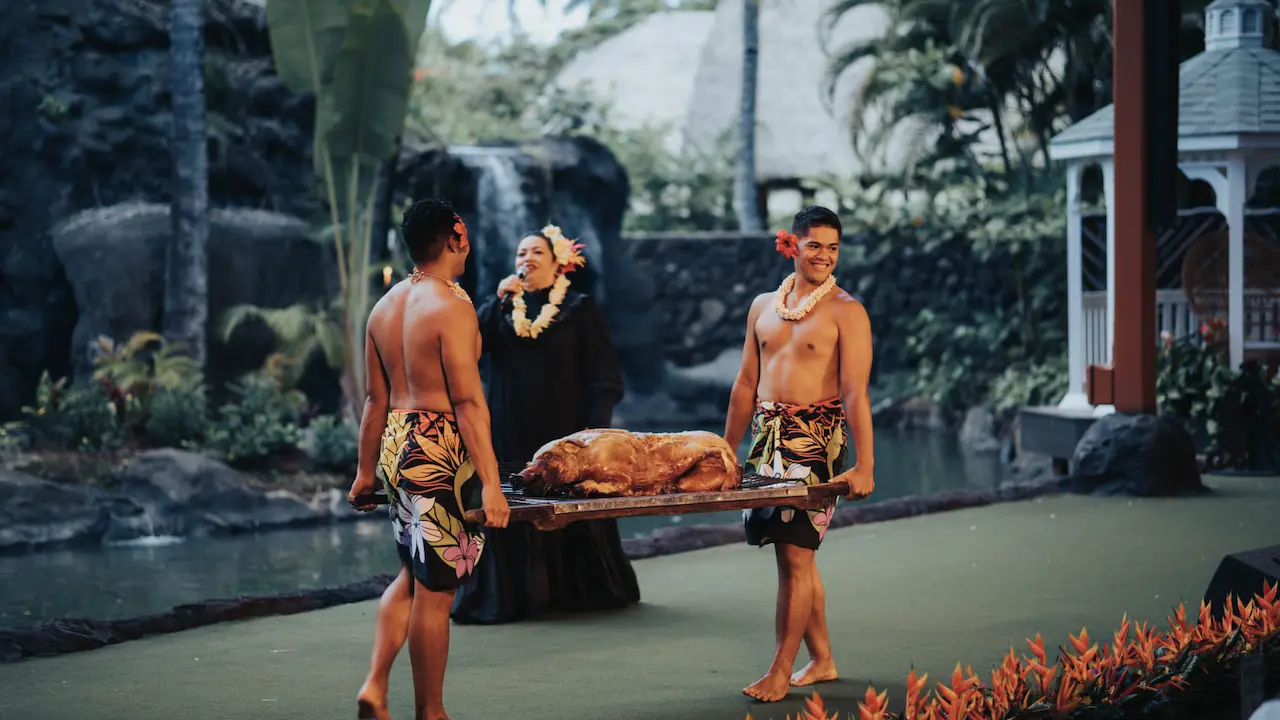 Men presenting the whole roasted pig prepared for the lūʻau dinner.