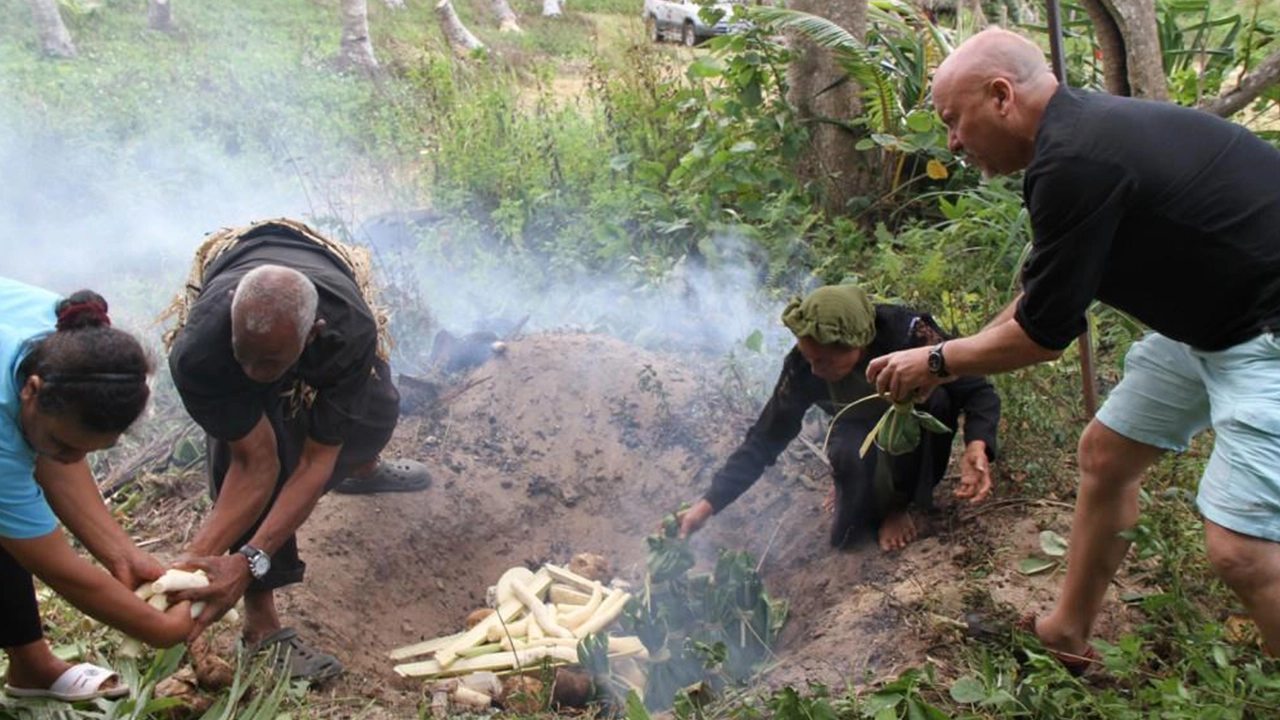 Men preparing an ʻumu.