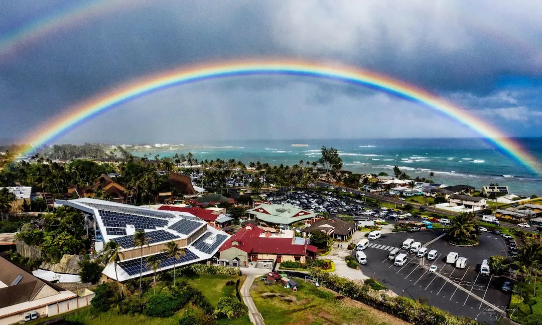 Rainbows hover over the Polynesian Cultural Center in Lāʻie, Oʻahu, Hawaiʻi.