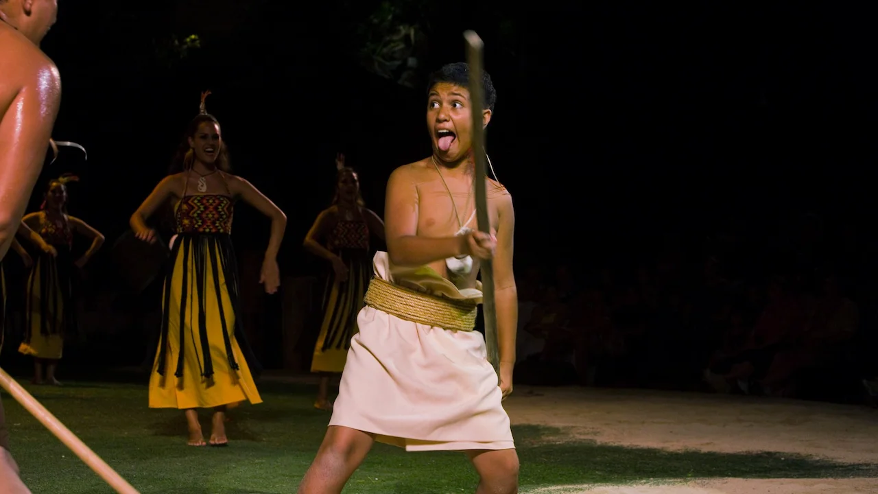 Young boy learning to use a wooden pole.