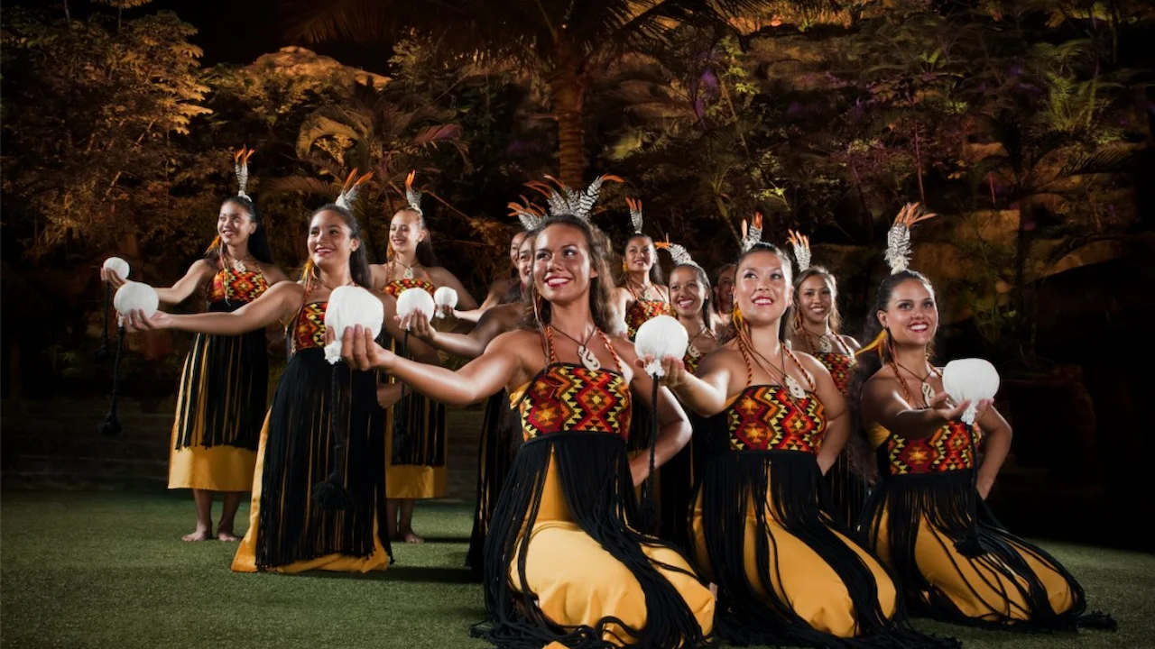 Several Māori performers holding their poi balls as part of the show.