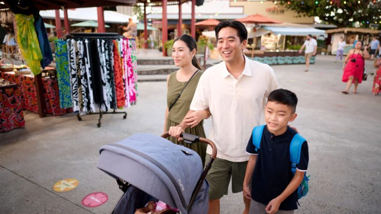 Parents with young son and infant shopping outdoors