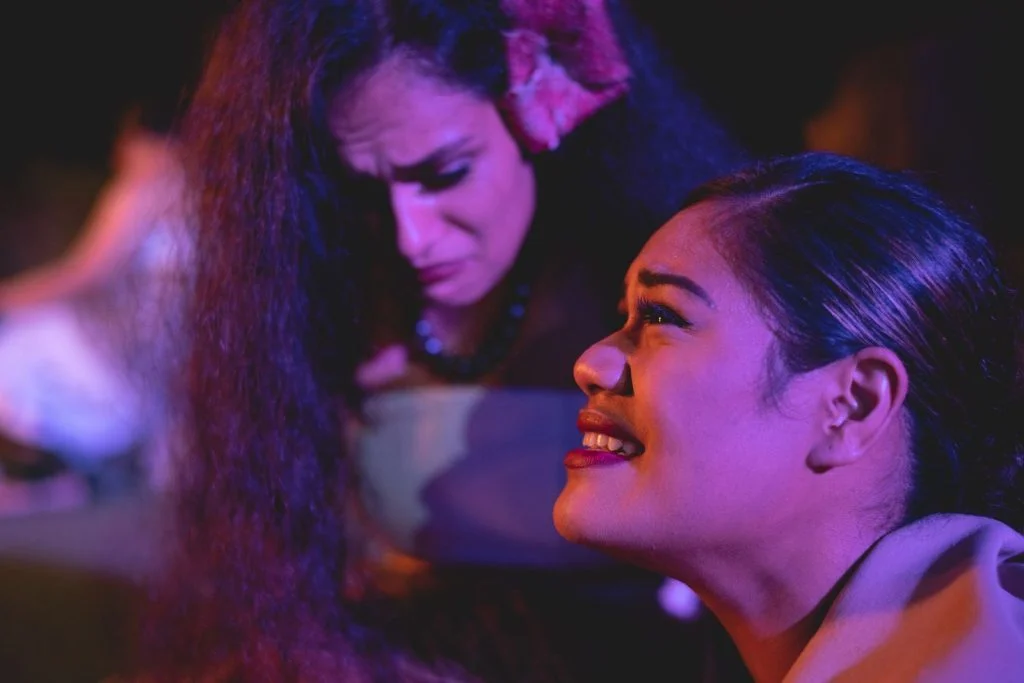 A close-up on two actresses performing a dramatic scene.