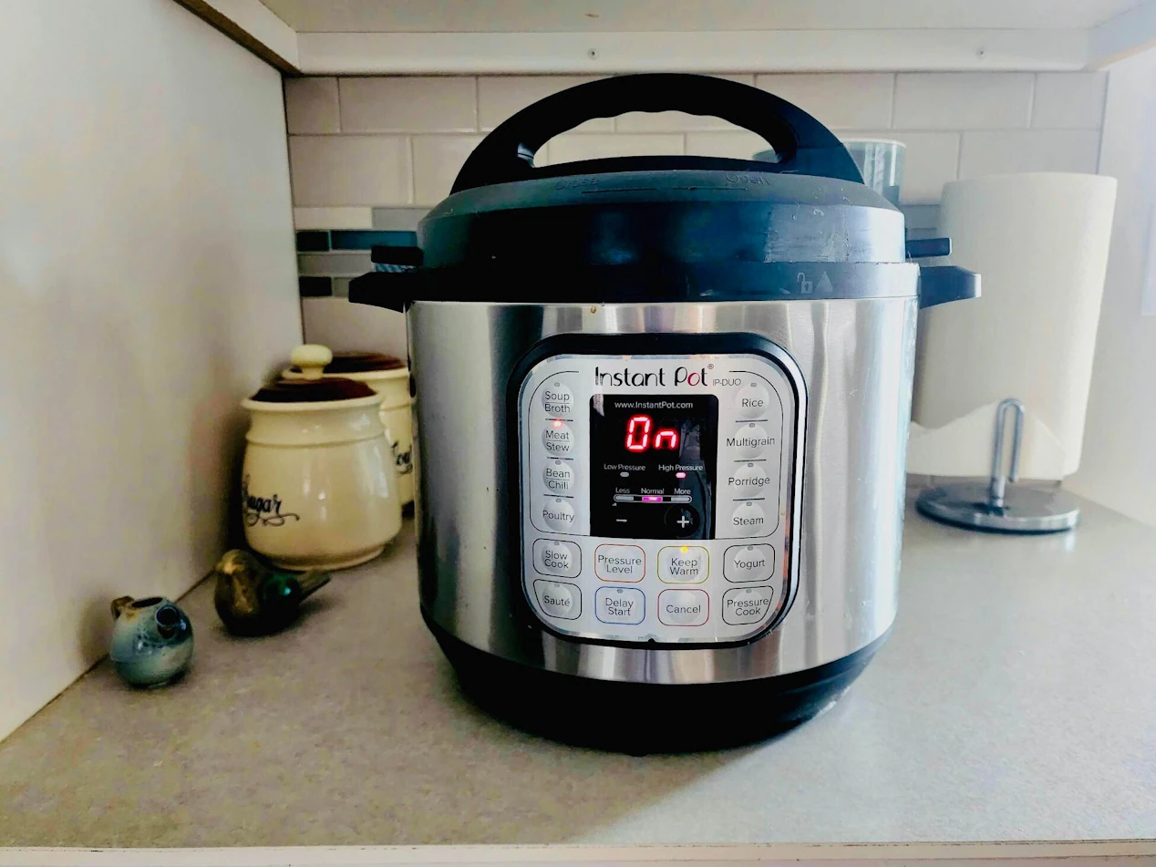 An Instant Pot pressure cooker powered on.