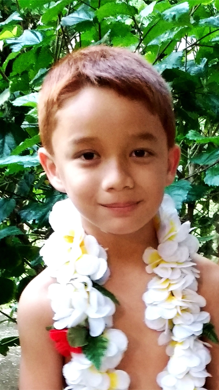 Young boy wearing a flower lei