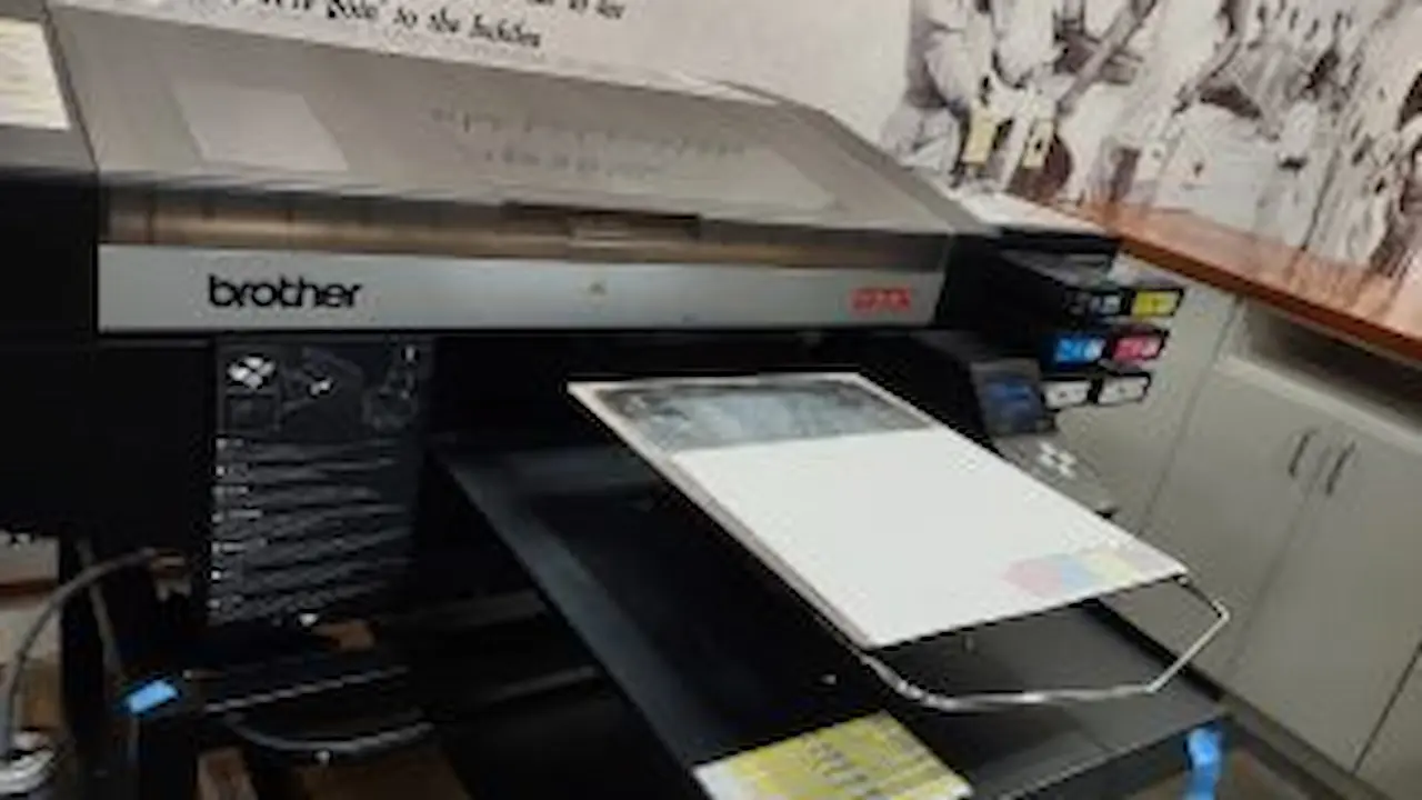 Large commercial printer being used to copy a design.